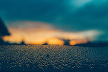 Sunrise through raindrops on a window 