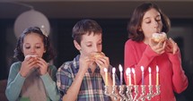 Kids and eating donuts with during Hanukkah.