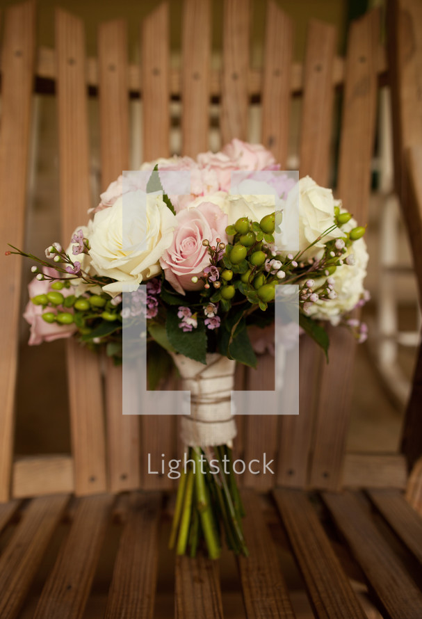 bridal bouquet resting on a chair 