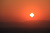 Red sunrise over distant mountains