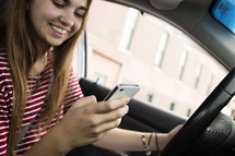 a teen girl texting while driving 