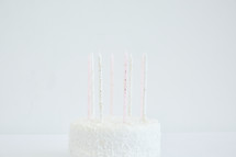 white birthday cake and birthday candles 