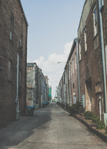 view of trash cans in an alley 