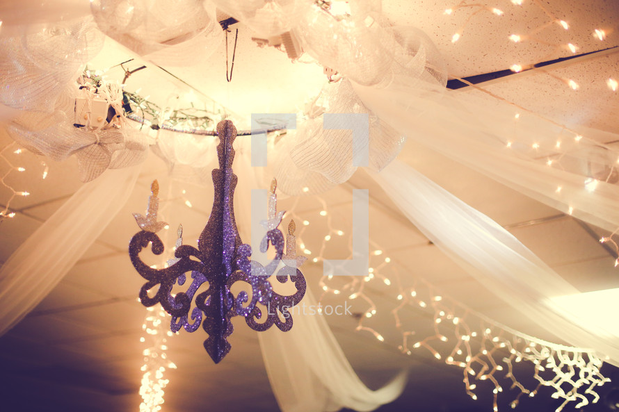 white tulle hanging from a chandelier 