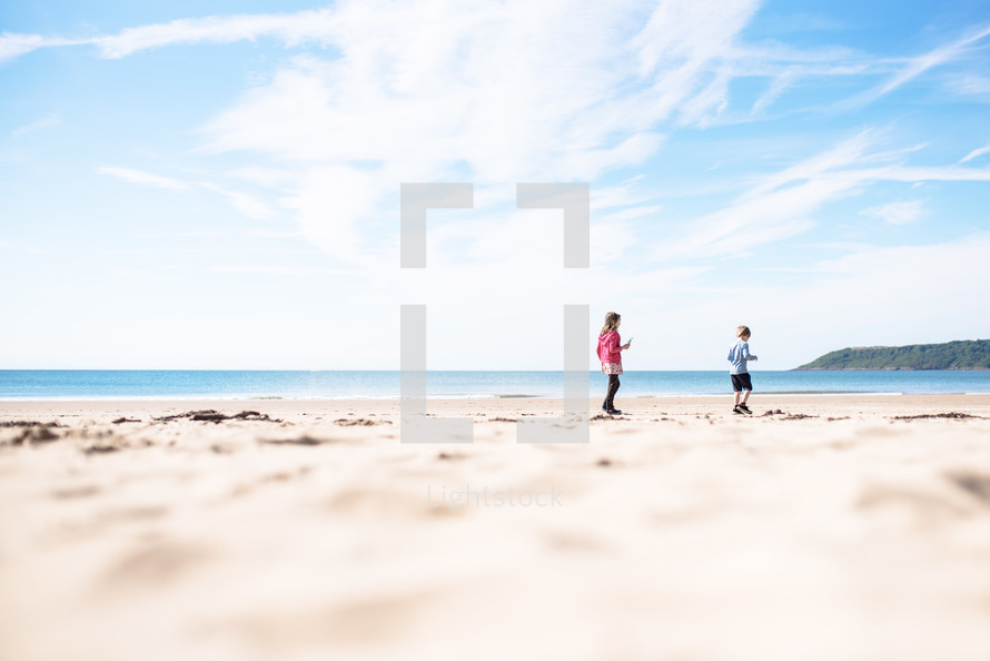 children walking on a beach 