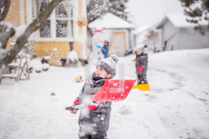 boys shoveling snow 