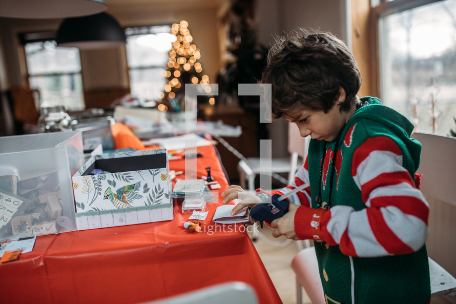a boy doing crafts at Christmas 