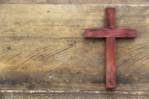 wooden cross on a wood background
