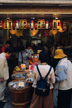 people shopping at a market in Japan 