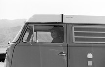 a man driving a VW bus