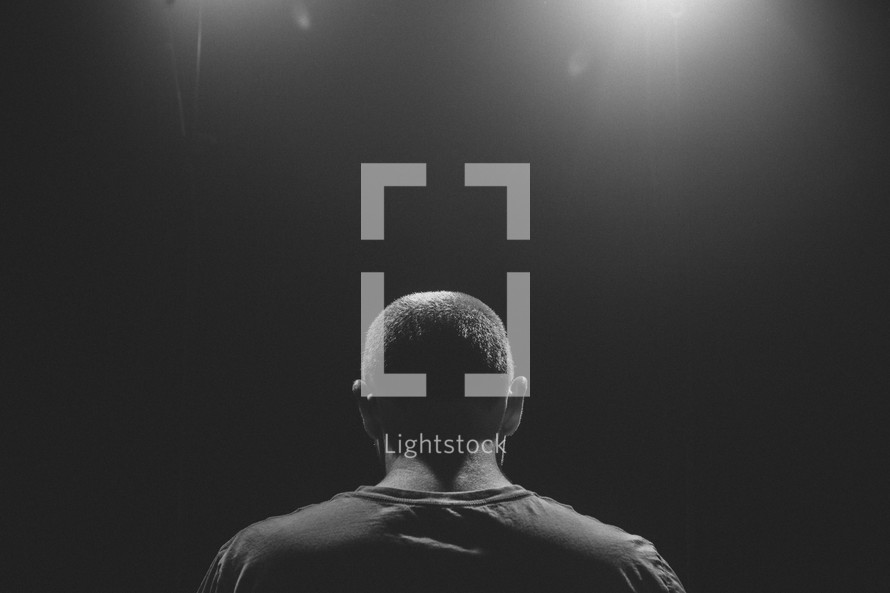 man standing under a spotlight