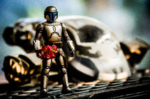 robot toy holding flowers 