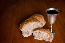 Broken bread and a chalice of wine.
