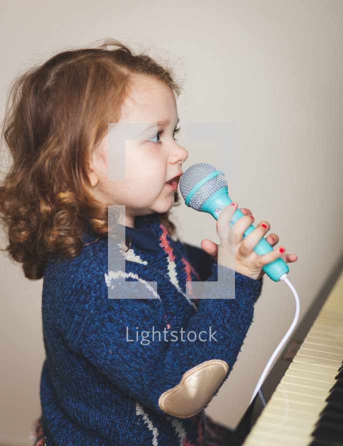 child singing into a microphone 