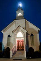 white church with steeple at night
