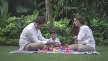 Smart Happy Asian Indonesian Child Playing and Learning with Toys Accompanied By The Parents - Family Time at Garden