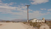 house and electricity pole in the desert