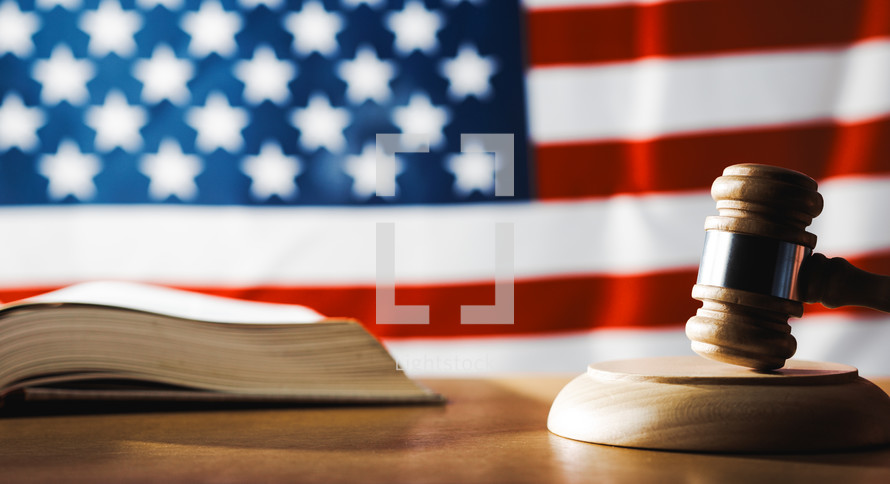 U.S. Supreme Court with gavel on a book and U.S. flag