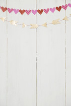 hearts and arrow banner on a white wall 