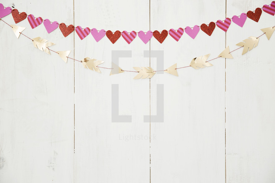 hearts and arrows banners on a white wall 