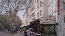 Paris, France - March 19, 2024: The ambiance of Rue Coquillière in Paris, bustling with many restaurants like the Au Pied de Cochon and cafes