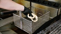 Frying The Onion Rings Inside A Pub Kitchen