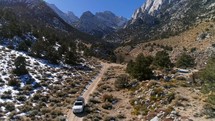 Aerial shot of a car driving off road in eastern Sierras in California, near Mount Whitney.