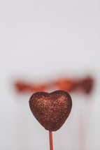 blurry red heart on a stick 