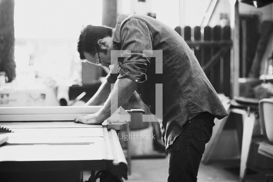 carpenter working at a table saw