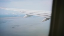 View From Airplane Window Over Water