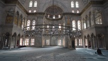 Muslim Man Salah salat Pray inside Nuruosmaniye Camii Mosque Architecturally significant Ottoman mosque Istanbul, Turkey