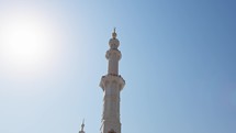 White minaret with blue sky