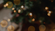 bokeh Christmas lights around a Christmas tree