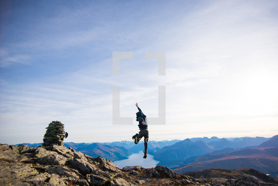 man jumping on a mountainside 