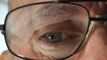 Close up of a mature man's eye with glasses