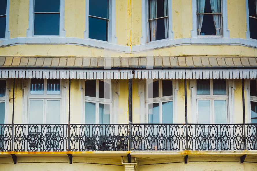 balconies on a yellow building 