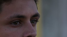 Close up of a young man staring while in deep thought