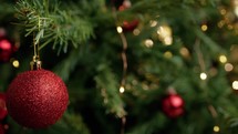 Red balls adorning a Christmas tree for holidays