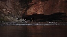 River flow, calm waters in slow motion, brown cliffs in the background