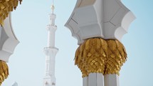 Golden Column Details With the Mosque Tower in Background