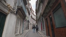 Porto, Portugal - A narrow street alleyways by the Douro River, Porto's old town with historic buildings and restaurants, the promenade and Ponte Luís I bridge.