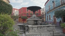 Walking on Plaza with Fountain and Colorful Buildings Guanajuato, Mexico