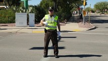 A policeman directing traffic in a small town