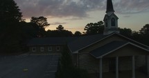 a church parking lot at sunset and an aerial tour over a neighborhood 