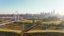 Aerial video of the Margaret Hunt Hill Bridge in downtown Dallas, Texas on a beautiful clear blue sky morning