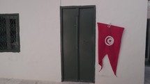 Tunisian Flag on White Wall in Sidi Bou Said, Tunisia