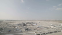 Overview of a large airport with planes and terminals