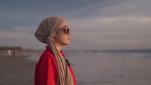 Modern Muslim Woman on Hijab Southeast Asian - Portrait, Smiling, looking to The Sunset. Beautiful Optimistic Hopefull Attractive Close Up