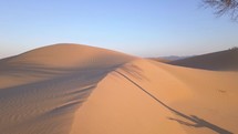 Aerial lift over a sand dune in a desert wilderness