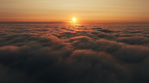Flying above heavenly clouds at sunrise aerial